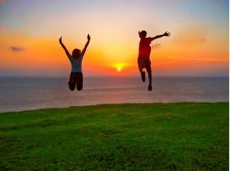 Kids Jumping in Meadow